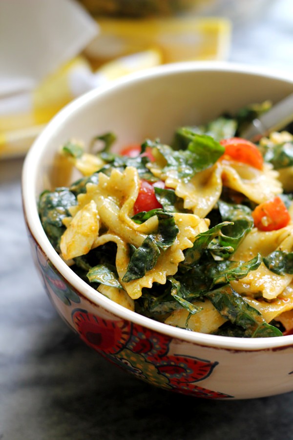 Tuscan kale, bell pepper, zucchini, and tomato pasta salad with basil pesto vinaigrette