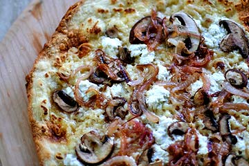 Ultra-thin-crust pizza with onions, mushrooms, and ricotta