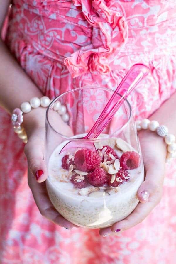 Vanilla bean coconut quinoa pudding with honey drizzled raspberries