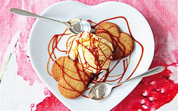 Vanilla ice cream with salt caramel sauce and heart biscuits