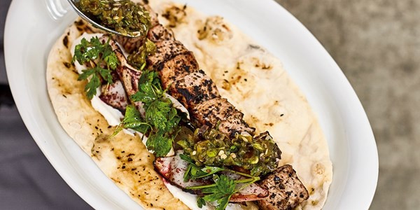 Veal shish and onion salad flatbread with charred sivri biber relish