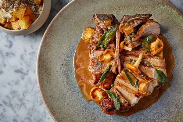 Veal T-bone with girolles, sage, crispy potatoes and cheese sauce