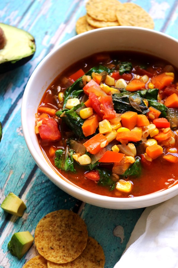 Vegan sopa Azteca with red lentils and baby greens