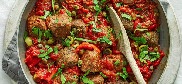 Veggie meatballs with tomatoes, olives and caper sauce
