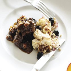 Venison and prune daube with roast cauliflower, olive and pine nut salad