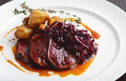 Venison leg cooked in hay with roast celeriac and braised red cabbage