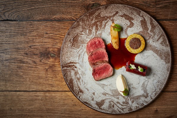 Venison loin with truffle gnocchi, braised cabbage and salsify