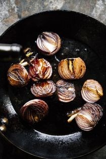 Vinegar-braised onions with seared whitefish and arugula
