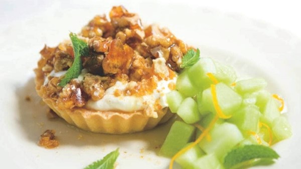 Walnut brittle and yoghurt tarts with ouzo and fresh melon