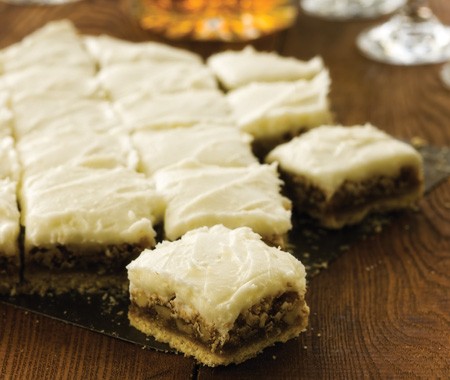 Walnut squares with white chocolate cream cheese icing