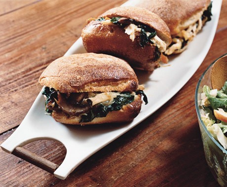 Warm chicken sandwiches with mushrooms, spinach, and cheese