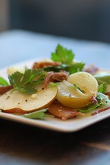 Warm duck confit, baked onion & pear salad