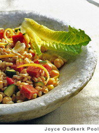 Warm farro salad with garden vegetables and salame