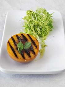 Warm grilled peach and frisee salad with goat's cheese dressing