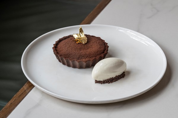 Warm molten chocolate and salted caramel tart with milk ice cream
