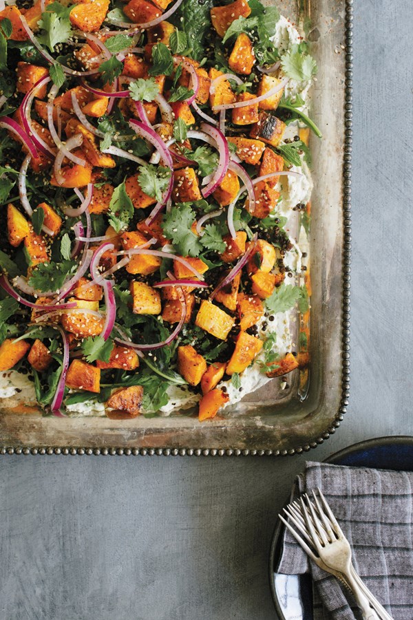 Warm roasted butternut squash and black lentil salad with herbs and tahini-yogurt dressing