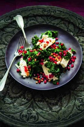 Warm salad of curly kale, feta, pomegranate and pine nuts