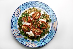 Warm salad of slow-roast tomatoes, labne and almonds, on mujadhara