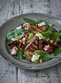 Warm salad of sweet and sour eggplants with cheese and pistachios