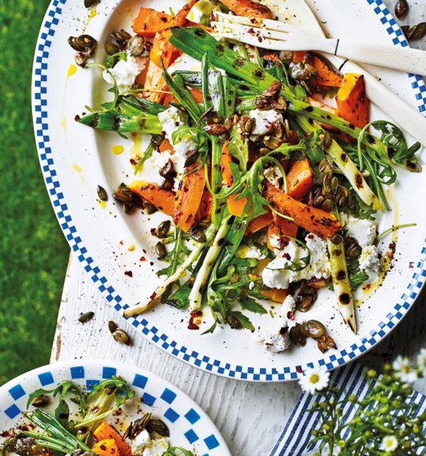 Warm squash and goats' cheese salad with griddled spring onions and pumpkin seed crunch