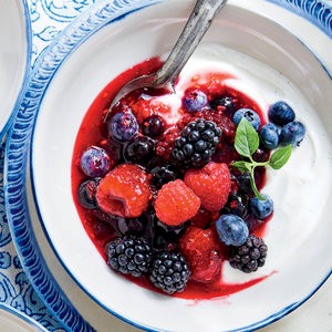 Warmed berries with honey and fresh cheese