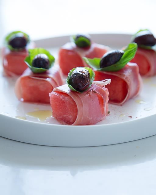 Watermelon with prosciutto, olives and basil