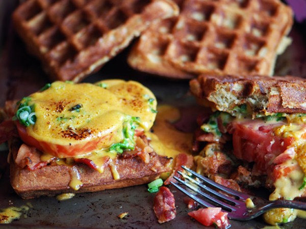 Welsh rarebit on beer waffles with bacon and tomatoes