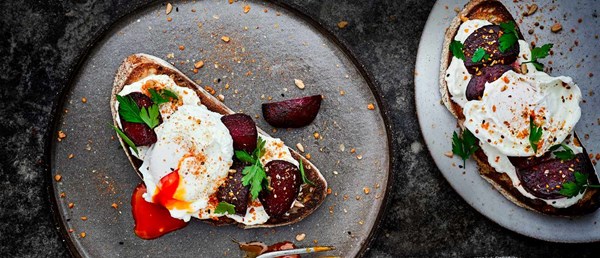 Whipped feta and beetroot on toast with poached eggs and dukkah
