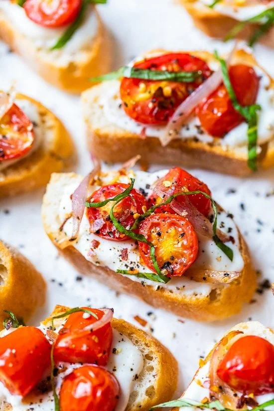 Whipped ricotta toast with roasted garlic, tomatoes and shallots