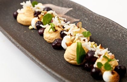 Whipped sea buckthorn with burnt meringue, crispy rice, blueberries and tonka bean gastrique