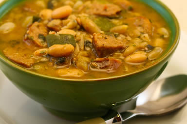 White bean soup with roasted turkey Italian sausage, zucchini, and basil