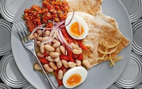 White beans with roast peppers, shaved red onion, warm boiled eggs and hilbeh