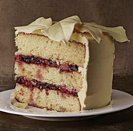 White chocolate macadamia cake with raspberries and white chocolate buttercream