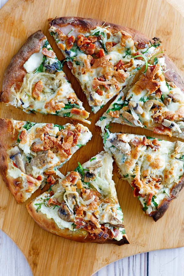 White pizza with arugula, bacon & mushrooms