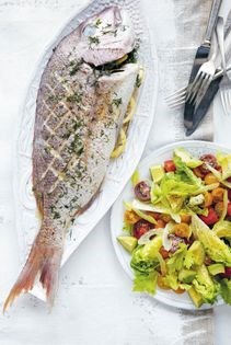 Whole baked snapper with tomato and avocado salad