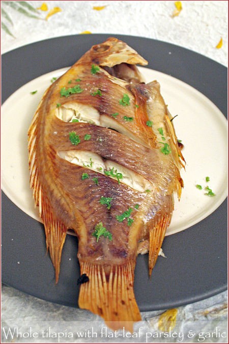 Whole baked tilapia with flat-leaf parsley and garlic