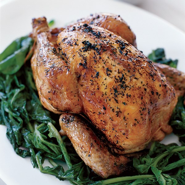 Whole grilled chicken with wilted arugula