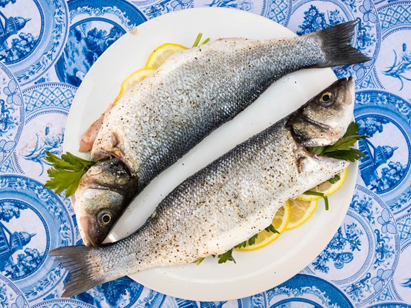Whole grilled fish with olive-tomato compote
