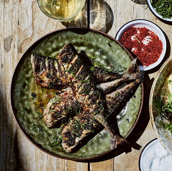 Whole mackerel over coals with garlic and garden leaves