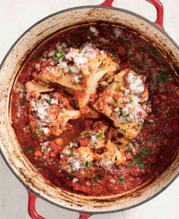 Whole pot-roasted cauliflower with tomatoes and olives