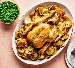 Whole roast chicken with braised veg & peas