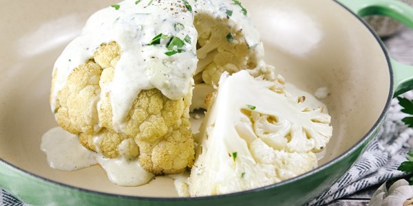 Whole roasted cauliflower with a garlic and herb sauce