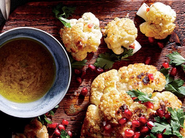 Whole roasted cauliflower with pomegranate and pine nuts