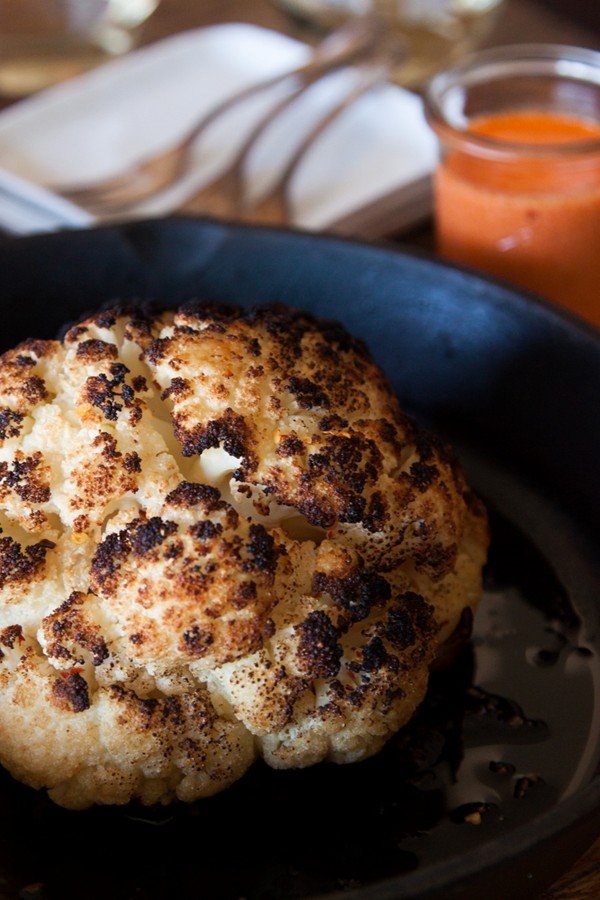Whole roasted cauliflower with roasted red pepper goat cheese sauce
