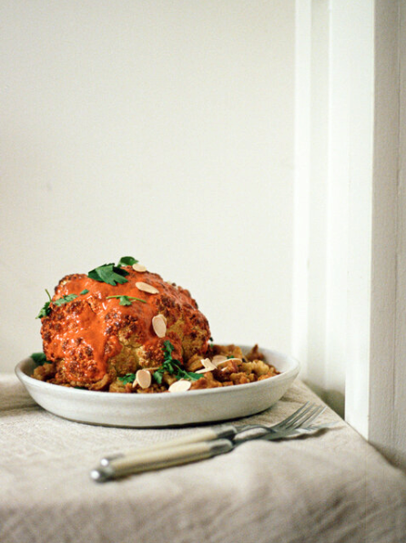 Whole roasted gochujang cauliflower with smashed roasted butter beans