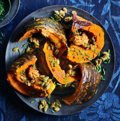 Whole roasted kabocha squash with umami butter & candied pepitas