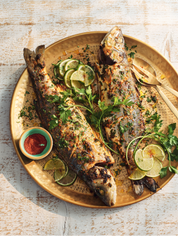 Whole seabass with herbs, lime and orange zest