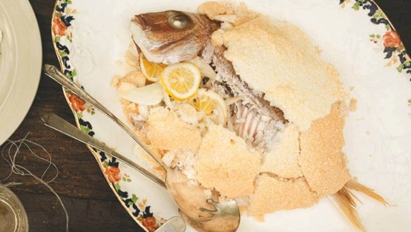 Whole snapper baked in salt crust with cracked potatoes, vinegar and olives