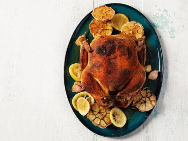 Whole spice-rubbed chicken with roasted garlic and lemons 