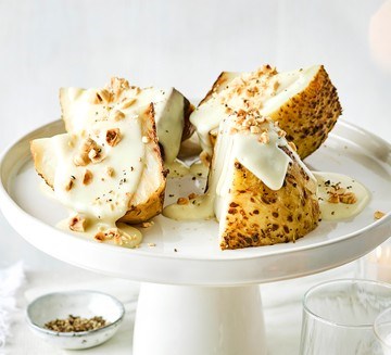 Whole truffle roast celeriac with cheese sauce & hazelnuts